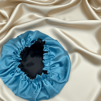 Blue satin hair bonnet on beige satin fabric
