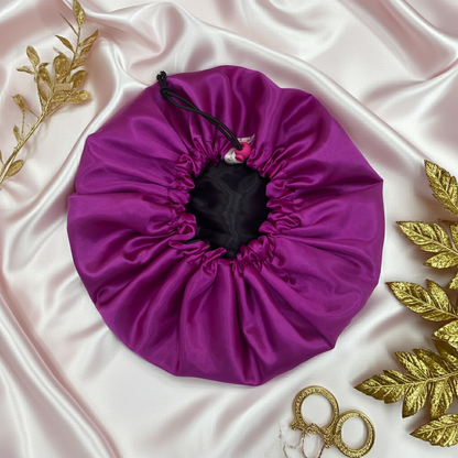 Purple drawstring bag on a satin surface with gold leaves and scissors.