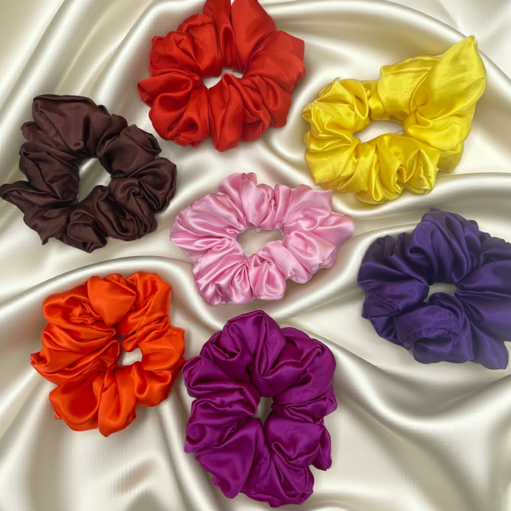 Set of colorful scrunchies on a satin surface